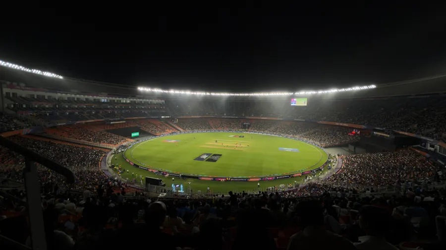 Floodlit cricket stadium packed for a night match