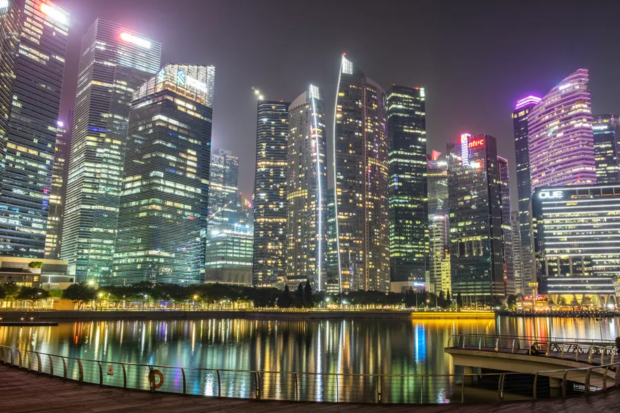 Singapore skyline at night across Marina Bay